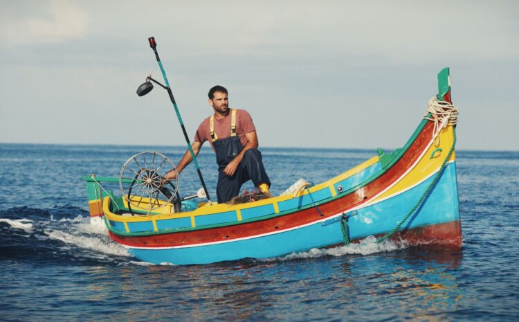 A still from the film Luzzu showing a fisherman on the traditional Maltese Luzzu