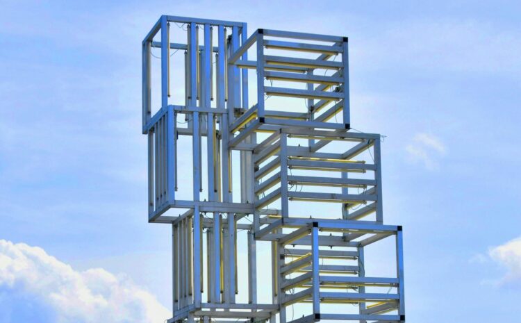 A detail from a geommetrical public artwork agaisnt a blue sky